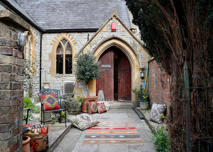 A photo of a path leading to a church door, the entrance to The Richard Harvey Collection's showroom in Shipston-on-Stour